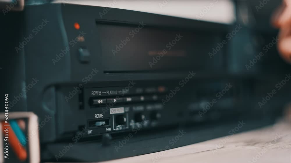 Vhs Machine Rear Female hand pulls out VHS from a vintage videotape recorder. Eject VHS ...