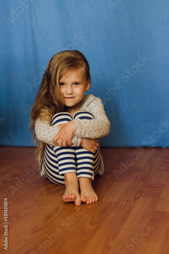 little girl sitting on the floor
