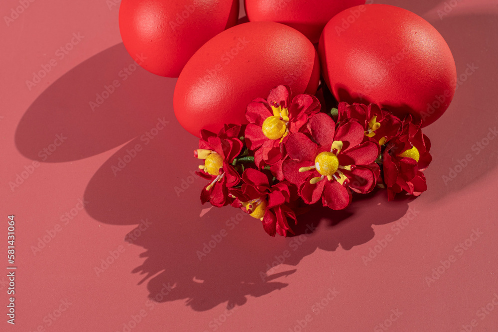 Colorful eggs, symbolizing Easter, on a colorful background and flowers