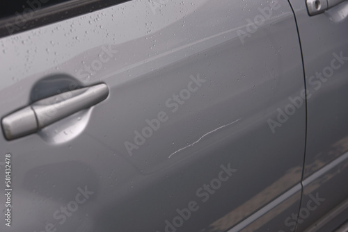 Obraz na płótnie Сar door scratched, damage to paint and lacquer coat. Dent car scratch. Vandal scratched car with nail at parking lot. . w salonie