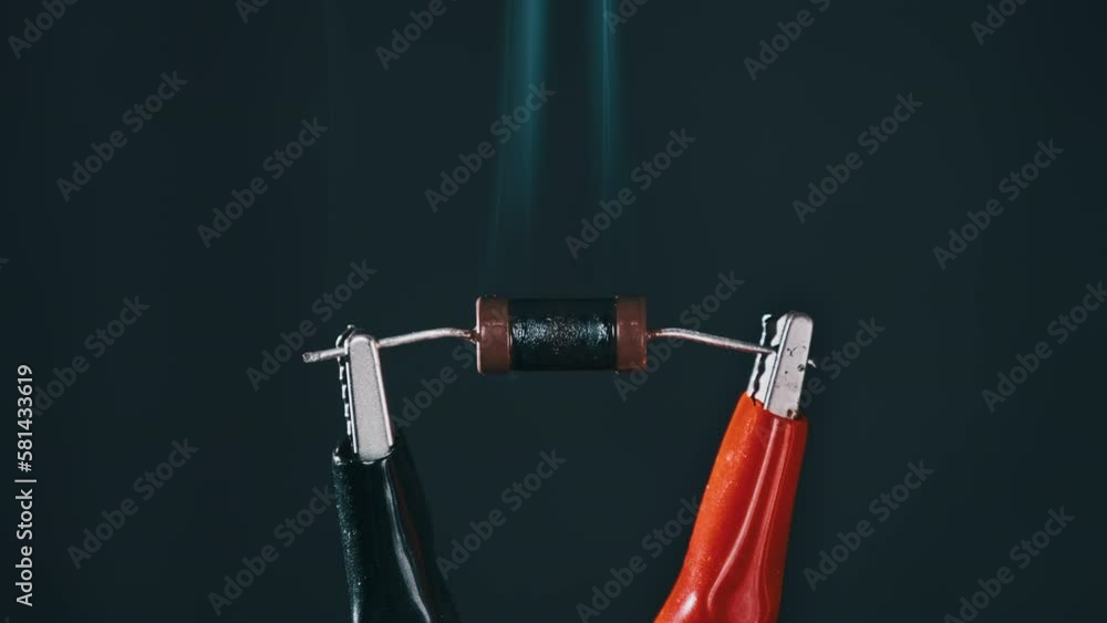 The resistor heats up with smoke under a high electric current, short