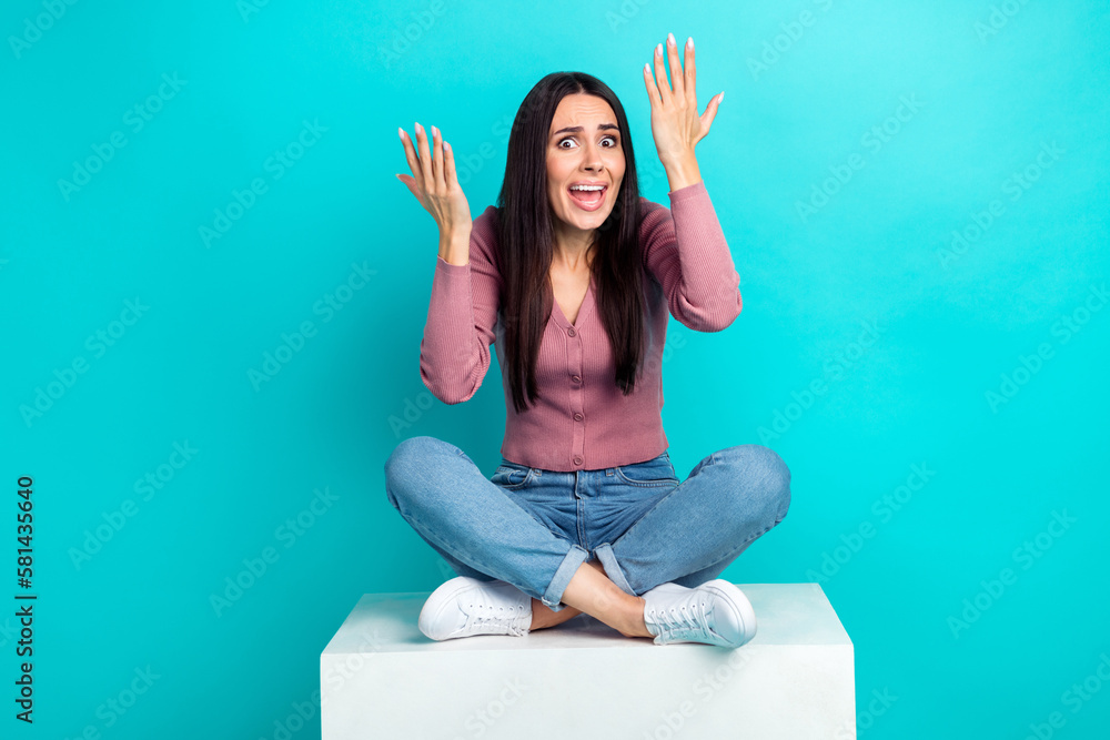 Photo of offended dissatisfied girl straight hairdo pastel cardigan sitting on cube complains isolated on vibrant teal color background - obrazy, fototapety, plakaty 
