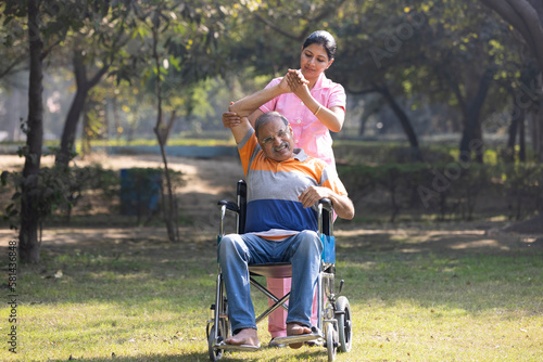 Senior man making physiotherapy session with young nurse.