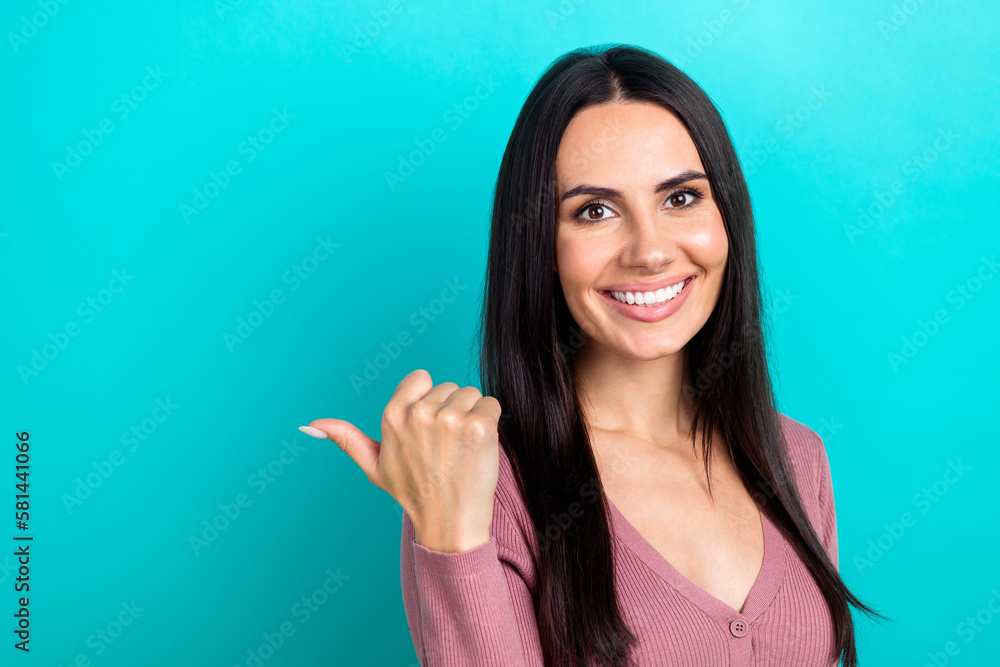 Fototapeta premium Portrait of optimistic young brunette hair girl wear stylish blouse direct thumb empty space opening new cafeteria isolated on cyan color background