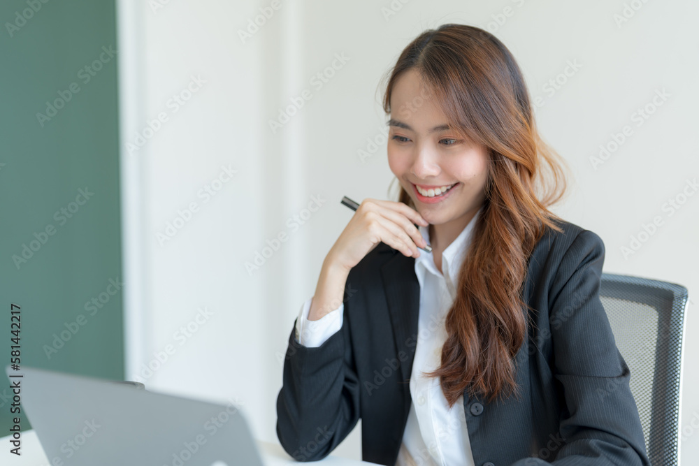 Businesswoman working on a laptop for business information. Businesswoman working on a laptop for business information.