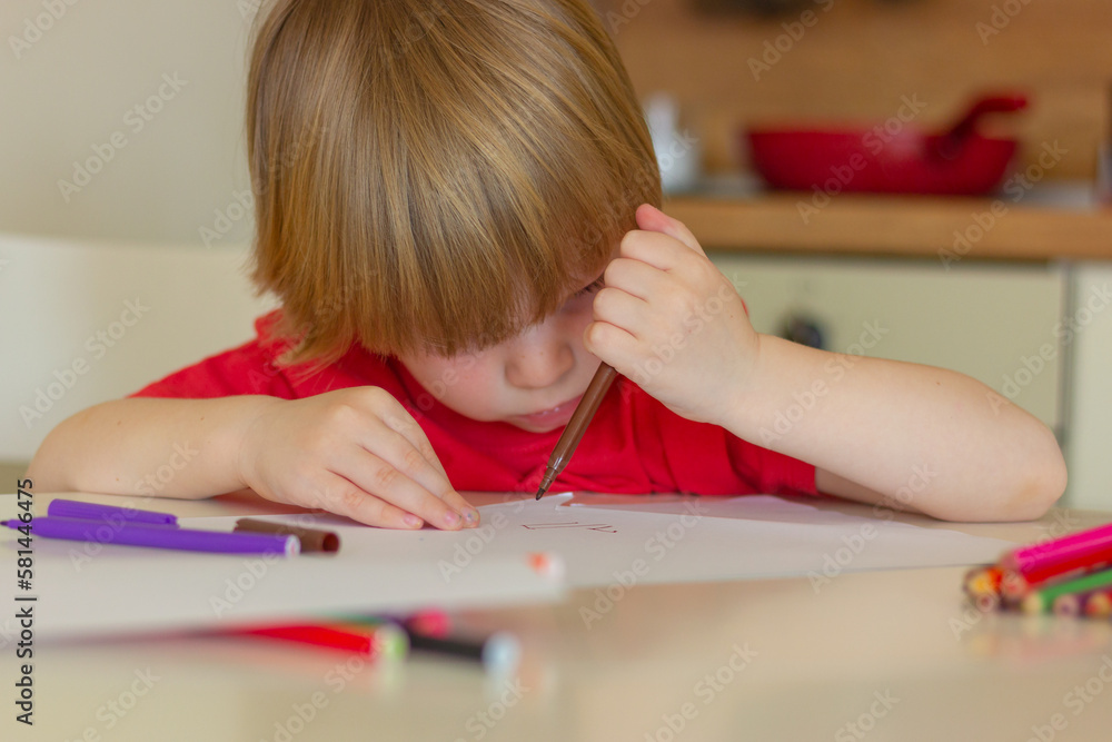 cute child tries to draw with colored felt-tip pens on paper cute child tries to draw with colored felt-tip pens on paper