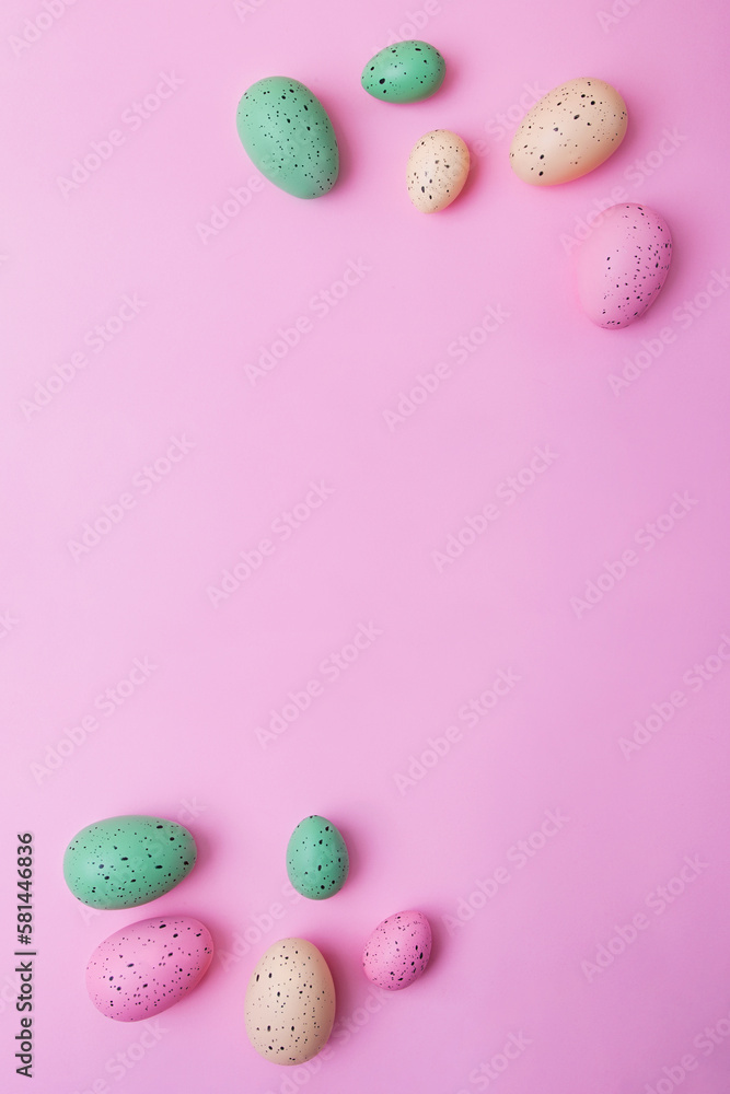 Vertical frame from multicolored eggs on pink background. Easter concept.