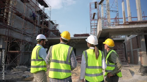 Construction engineer discussing and making plans with architect at construction site.