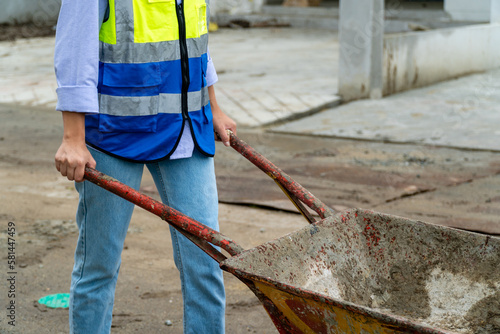Workers are pushing cement carts at a construction site.