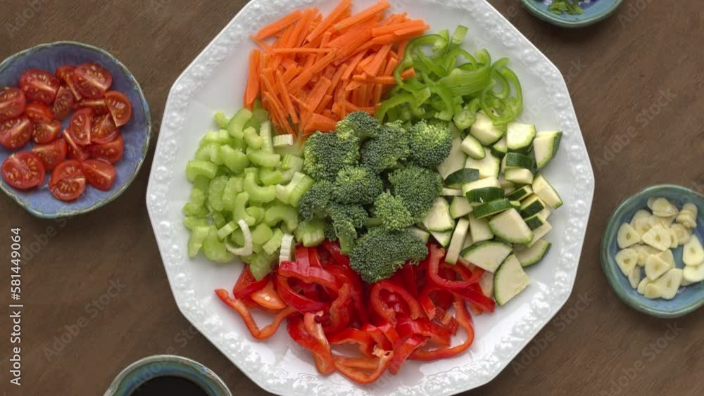 Ingredients for stir fry vegetables: broccoli, carrot, corrugate, celeriac, red and green pepper. Table spin, seamless loop. Ingredients for stir fry vegetables: broccoli, carrot, corrugate, celeriac, red and green pepper. Table spin, seamless loop.