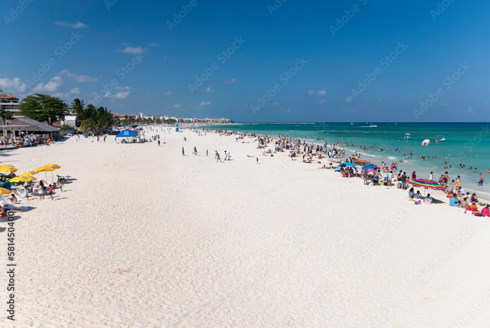 Panoramic view from above of tourists at the beach and sea on a sunny summer day in Playa del Carmen Mexico