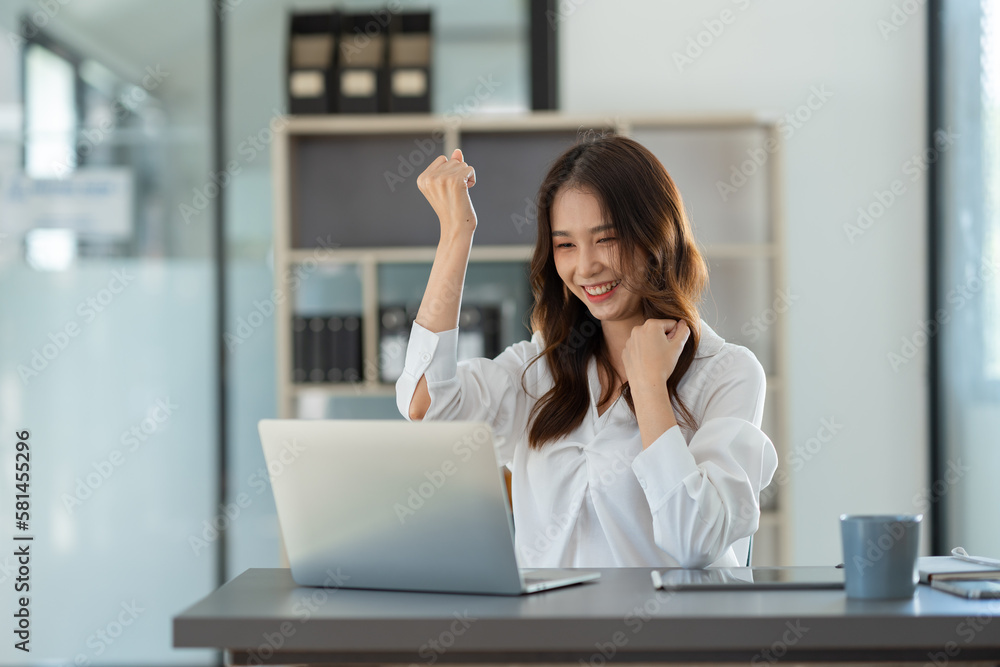 Beautiful Asian businesswoman working on a laptop computer doing financial, accounting analysis, reports, and data at the office. Beautiful Asian businesswoman working on a laptop computer doing financial, accounting analysis, reports, and data at the office.