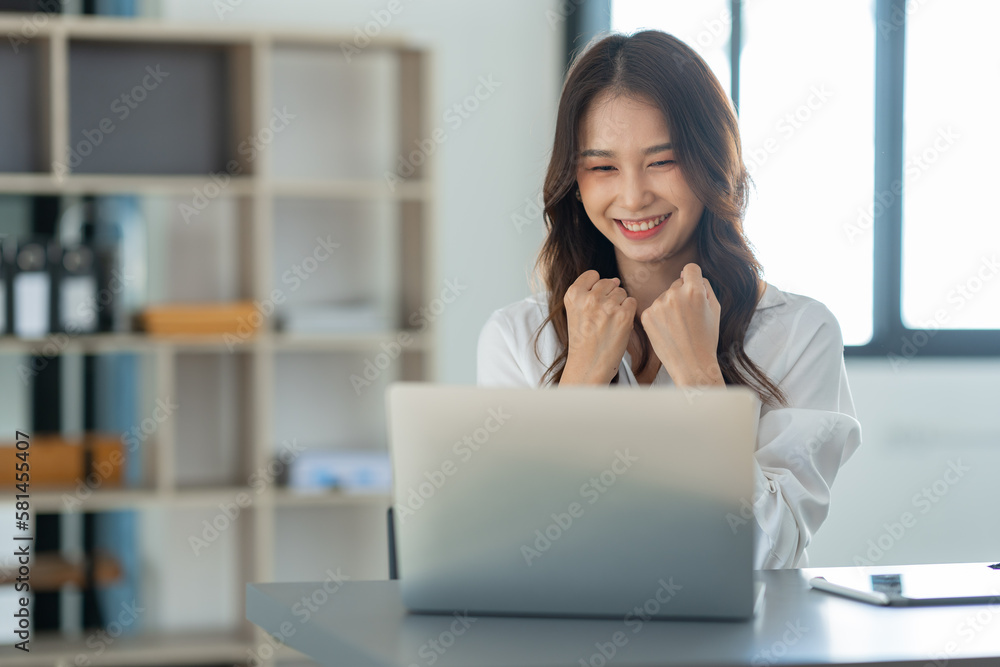 Beautiful Asian businesswoman working on a laptop computer doing financial, accounting analysis, reports, and data at the office. Beautiful Asian businesswoman working on a laptop computer doing financial, accounting analysis, reports, and data at the office.