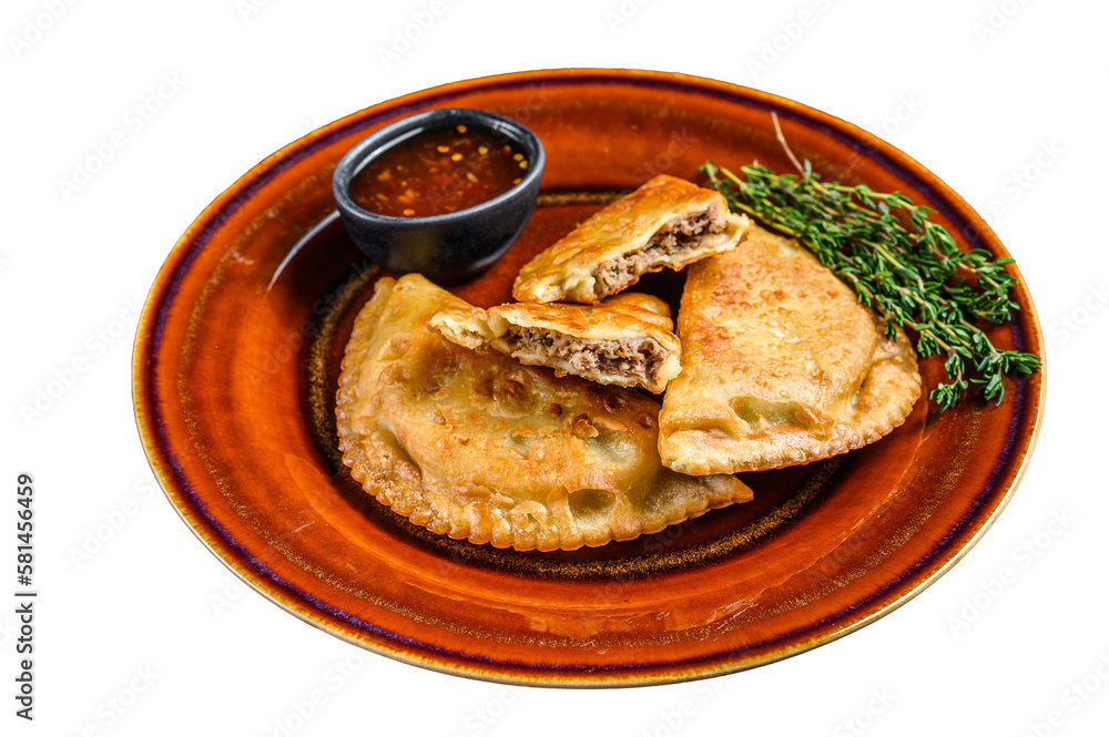 Fried empanadas with minced beef meat served on a plate with chili sauce.  Isolated, transparent background.