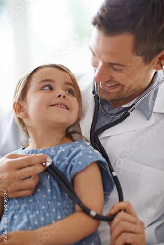 Breathe in. an adorable young girl with her pediatrician.