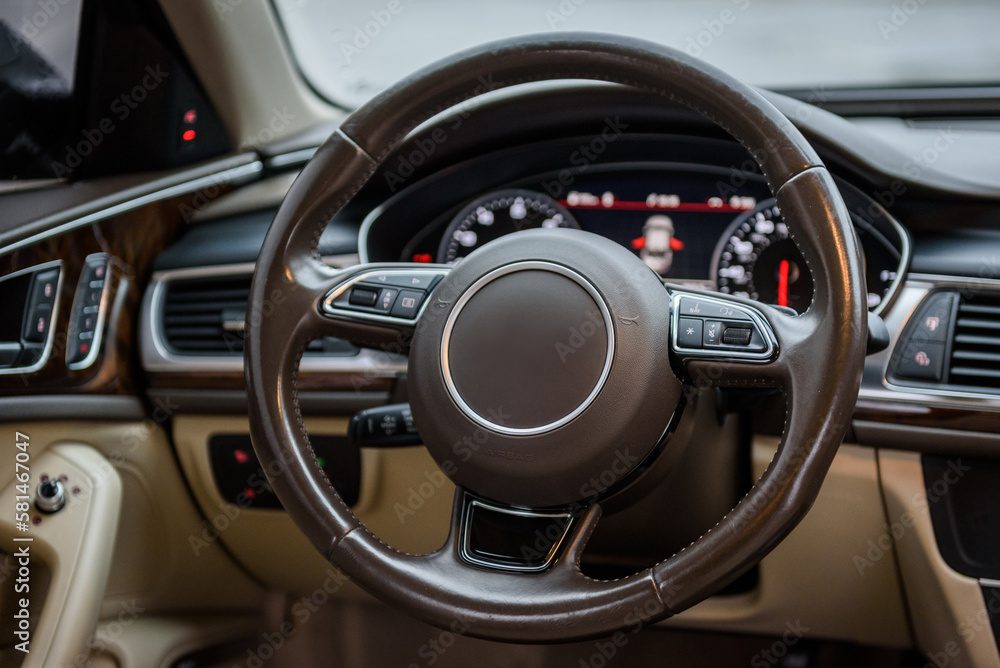 Steering wheel, speedometer, display, and multimedia dashboard. Luxury modern car interior business class. Detail of car interior inside. Closeup steer.