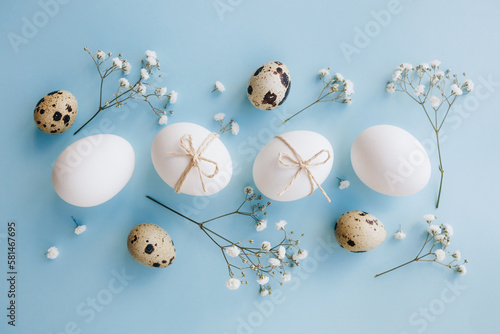 Canvas Print Composition with Easter eggs and flower blossom on blue background