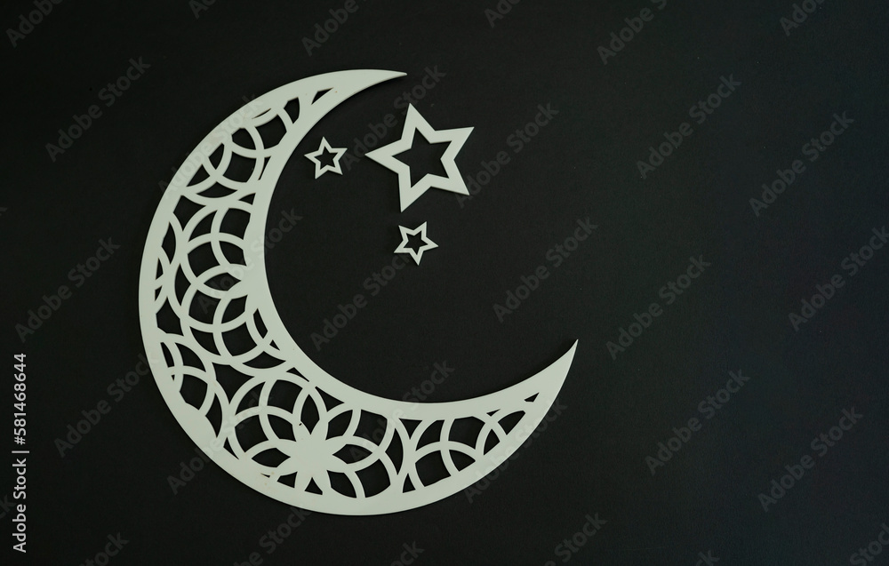 White crescent moon and some stars in a dark grey background, Ramadan and Eid concept Selective focus White crescent moon and some stars in a dark grey background, Ramadan and Eid concept Selective focus