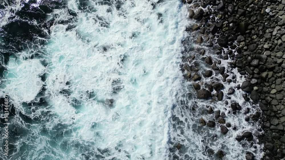 Aerial View to Ocean Waves. Blue Water Background. Top View of Foaming Blue Ocean Waters. Aerial View to Ocean Waves. Blue Water Background. Top View of Foaming Blue Ocean Waters.