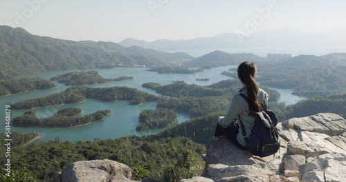 Woman sit on the rock and look at the scenery view