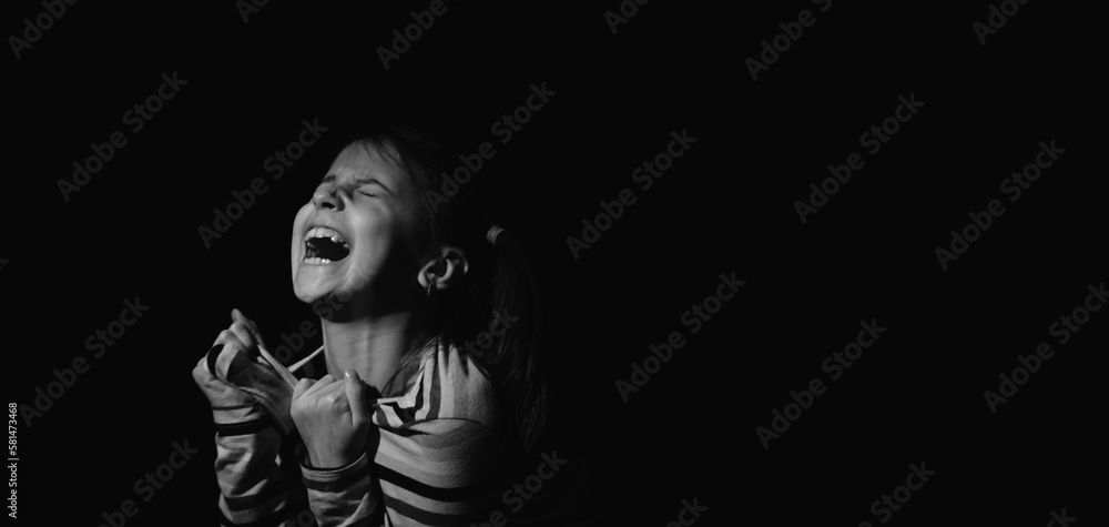 Loss childhood, mental health, depression, panic attacks and anxiety in children concept. Sad and nervous child girl screams for help. Copy space for text.
