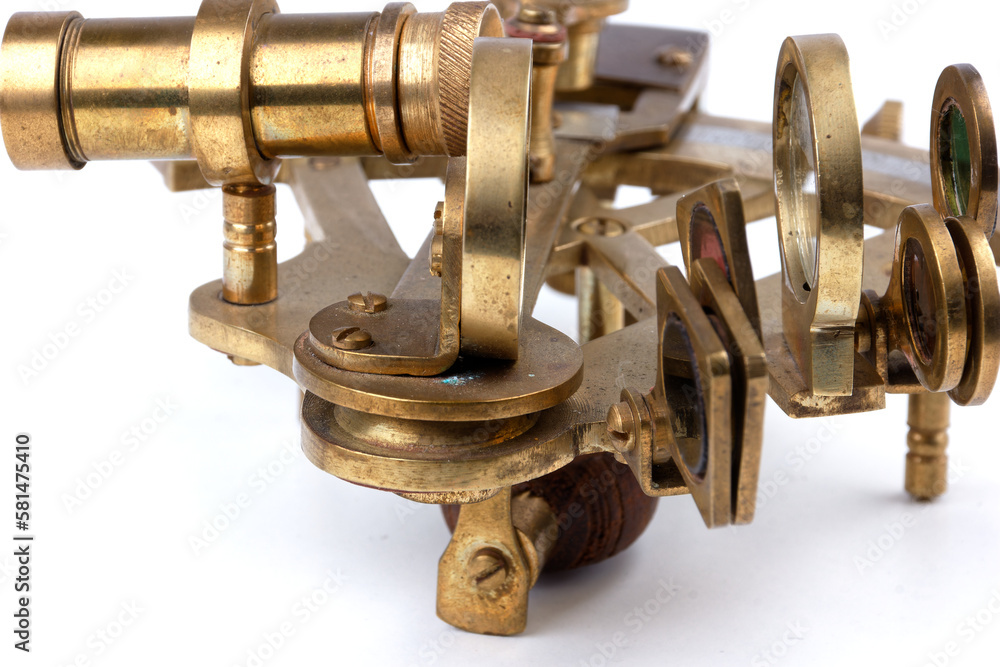 detailed view of a old nautical sextant with optics isolated on white background detailed view of a old nautical sextant with optics isolated on white background