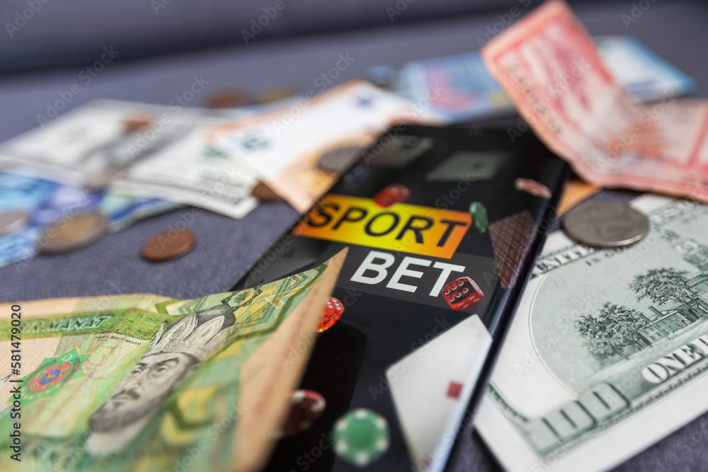 dollars and euros, smartphone with sports bet application dollars and euros, smartphone with sports bet application