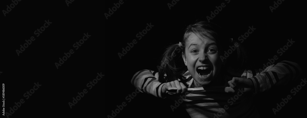 Conceptual image: loss childhood, pain, mental health, stress, psychology, depression, panic attacks and anxiety in children. Nervous child girl screams for help.  Copy space for text or design.