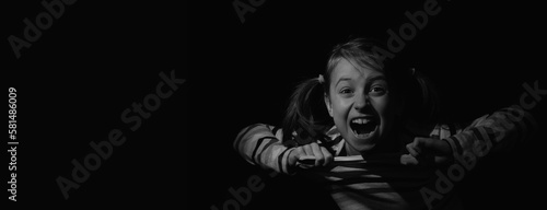 Conceptual image: loss childhood, pain, mental health, stress, psychology, depression, panic attacks and anxiety in children. Nervous child girl screams for help. Copy space for text or design.