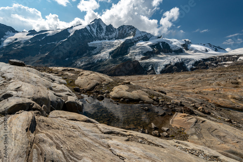 
Grossglockner mountain in autumn with lake rocks and yellow flowers in the foreground
in the Austrian Alps in the Hohe Tauern mountains