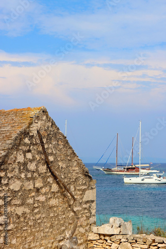 Traditional stone house and wild beach on Proizd, small island near Vela Luka, Croatia. photo