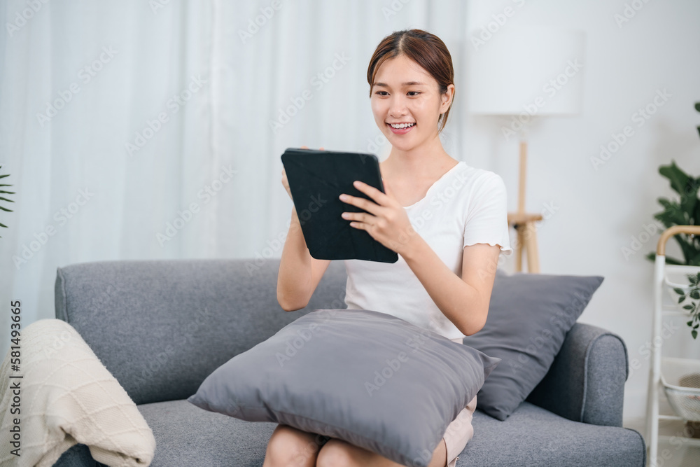 Young asian girl using digital tablet reading e-book for online learning. Young asian girl using digital tablet reading e-book for online learning.