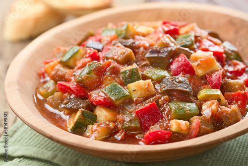 Fresh Ratatouille, a traditional French vegan vegetable stew made of eggplant, zucchini, bell pepper, tomato and onion with herbs (Selective Focus, Focus in the middle of the image)