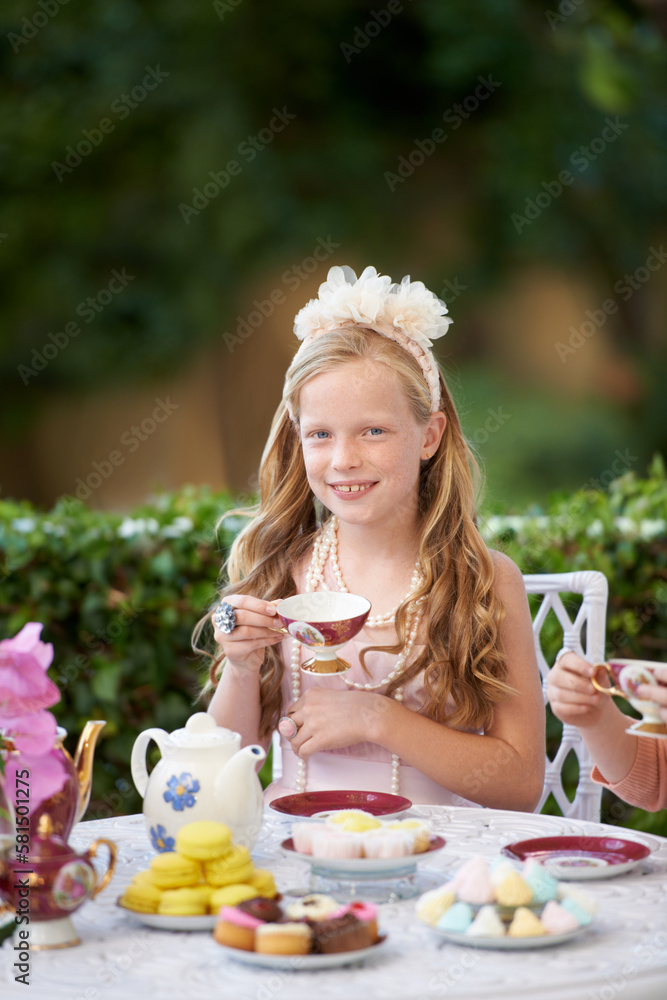 Flights of fancy. A cute little girl having a tea party outside. Flights of fancy. A cute little girl having a tea party outside.