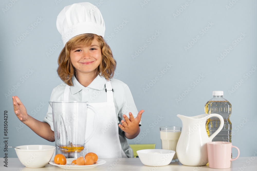 Child chef dressed cook baker apron and chef hat isolated on studio background. Healthy nutrition kids food. Child chef dressed cook baker apron and chef hat isolated on studio background. Healthy nutrition kids food.