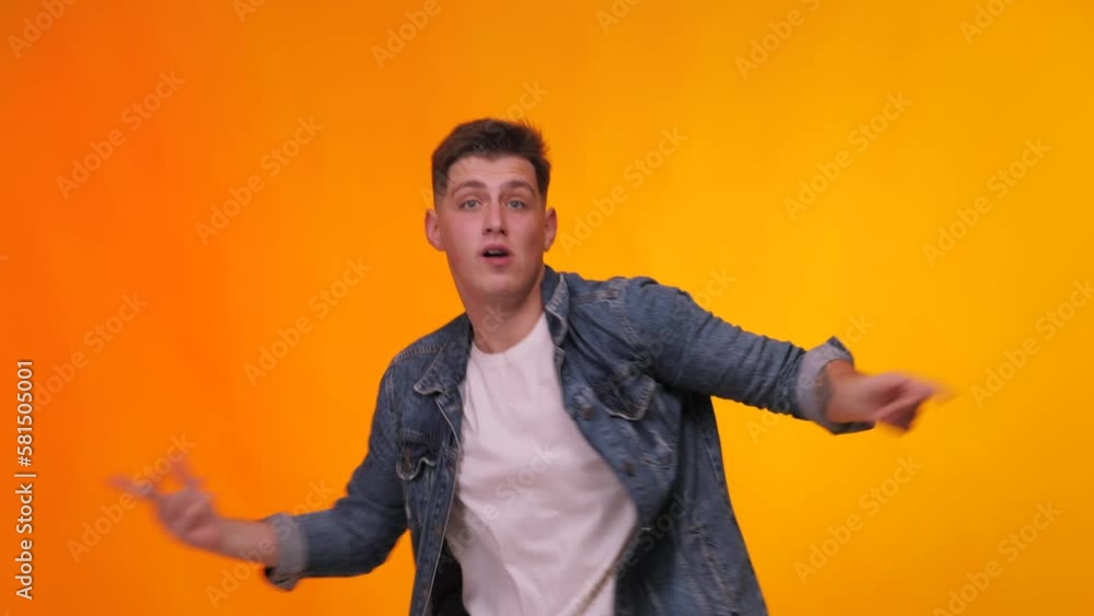Happy man dancing. Dancing guy. Party, music, lifestyle, radio and disco. Young handsome man dancing and having fun, moving arms listening to music. Happy man dancing. Dancing guy. Party, music, lifestyle, radio and disco. Young handsome man dancing and having fun, moving arms listening to music.