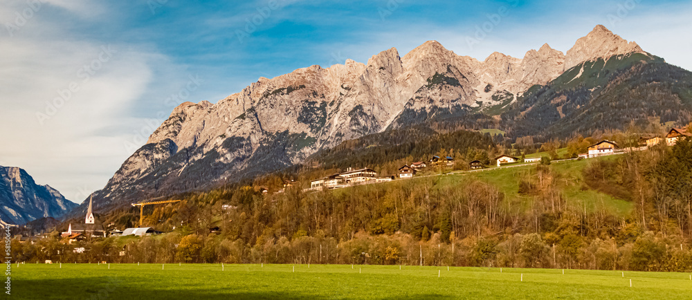 Alpine autumn or indian summer view with a church and the Tennengebirge mountains near Werfen, Salzburg, Austria