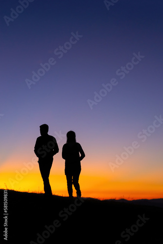 Silhouette of a couple in love at sunset background. Hadubai view point Ban Lao Wu, Wiang Haeng, Chiang Mai Copy space for use. Silhouette of lover on hill in sunset