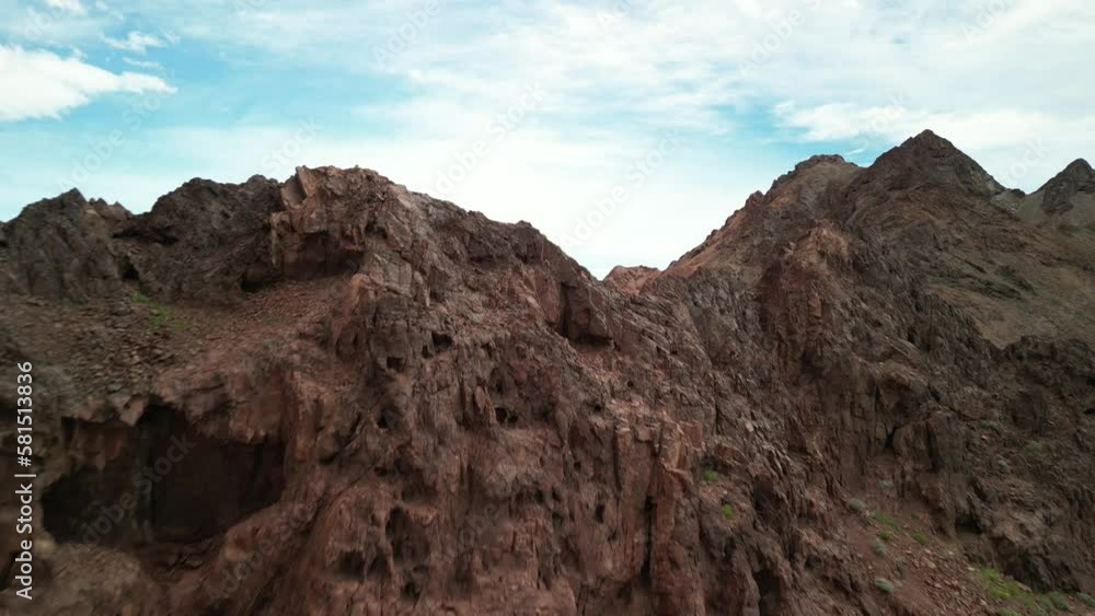 Aerial revealing over volcanic rocks to red mountain landscape in Baja California Mexico along Sea of Cortez Aerial revealing over volcanic rocks to red mountain landscape in Baja California Mexico along Sea of Cortez