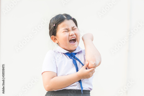 A Child Crying Out Loud Because of an Abrasive Wound on His Arm,A cute young injured girl with a band aid on his elbow,agape