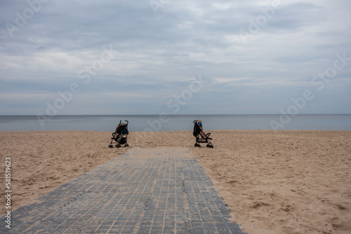two baby trolleys left behind on the beach at the baltic sea in Germany
