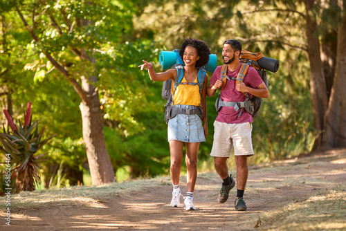 Couple With Backpacks On Vacation Hiking Through Forest Countryside Together © Monkey Business