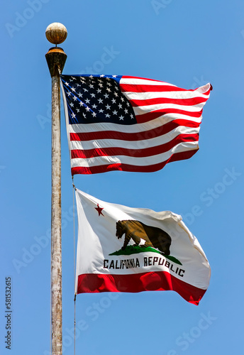 State flag of California - United States of America on blue sky.