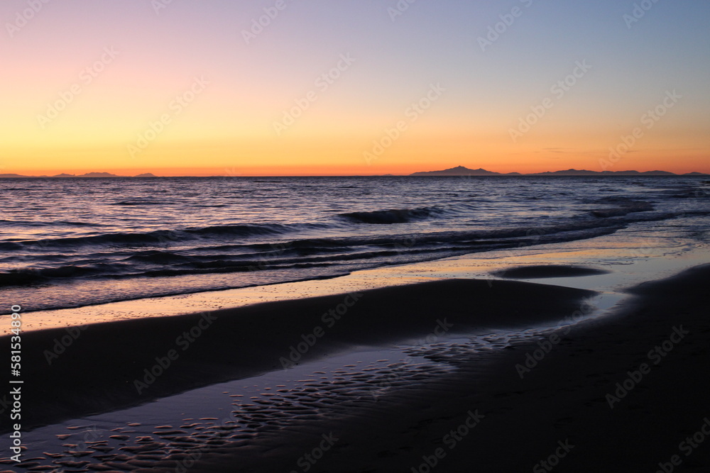 Sunset on the Tyhrrenian Sea from the beach of Alberese, Grosseto, in Tuscany, Italy. Horizontal.
