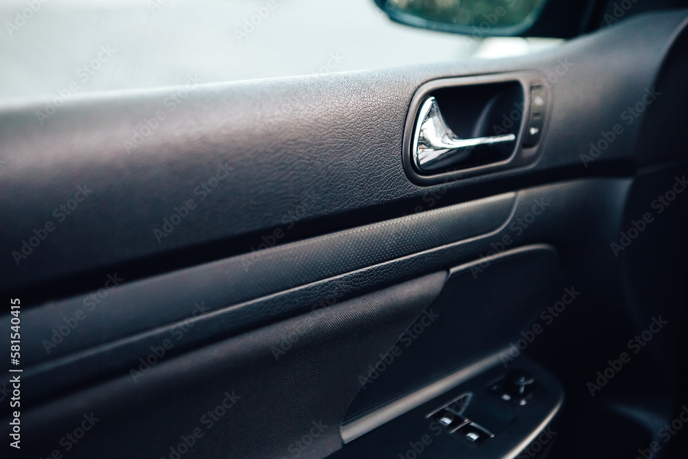 Close up door handle black dark car interior. Dashboard display panel. Climate control. Electric, hybrid elegant modern vehicle. Car detailing equipment.
Close up door handle black dark car interior. Dashboard display panel. Climate control. Electric, hybrid elegant modern vehicle. Car detailing equipment.