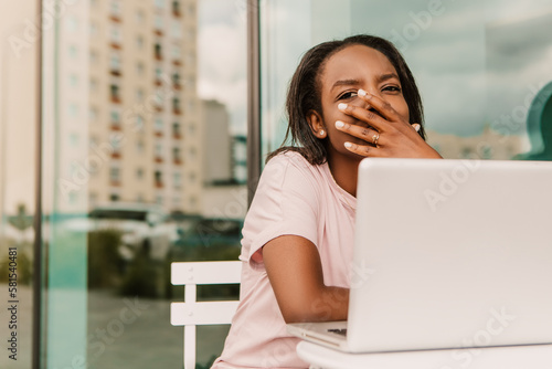 Tired exhausted overworked african american woman hipster sitting outside with laptop yawning. Young entrepreneur freelancer student businesswoman low energy need to sleep have a rest chill 