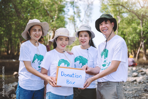Group of asian diverse people volunteer holding a donation box for fundraiser to emergency situation such as help ukraine, flood victims, food for children, charity event.Volunteering conceptual.