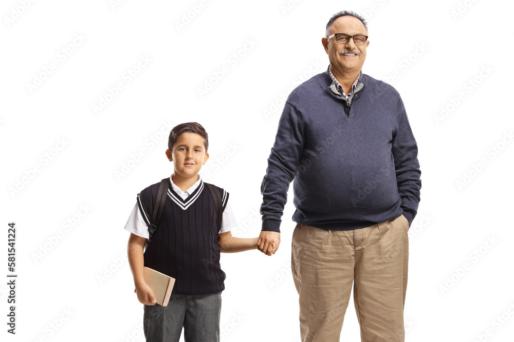 Portrait of a mature man holding hands with a schoolboy Portrait of a mature man holding hands with a schoolboy