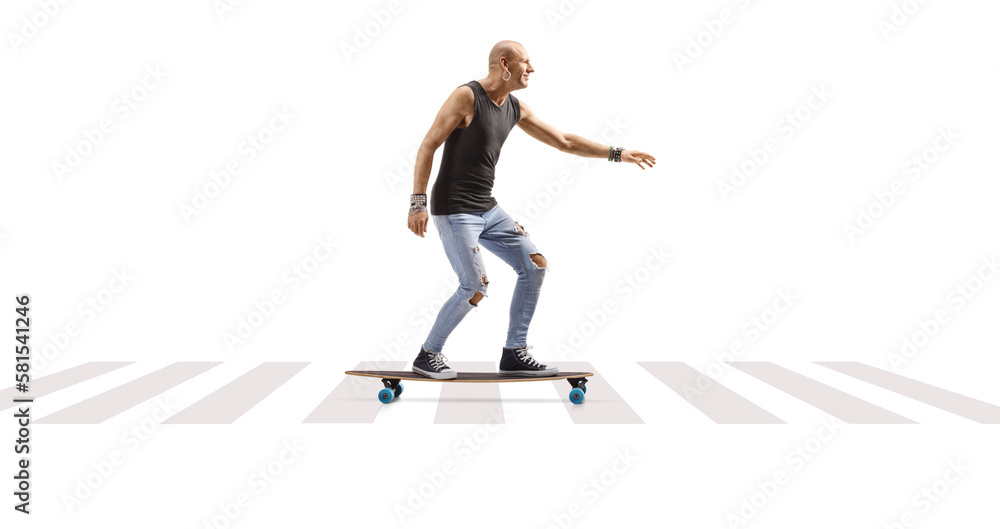 Male hispter riding a longboard at a pedestrian crossing