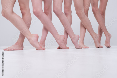 Fototapete Photo of several pairs of bare feet in a row during a rehearsal.